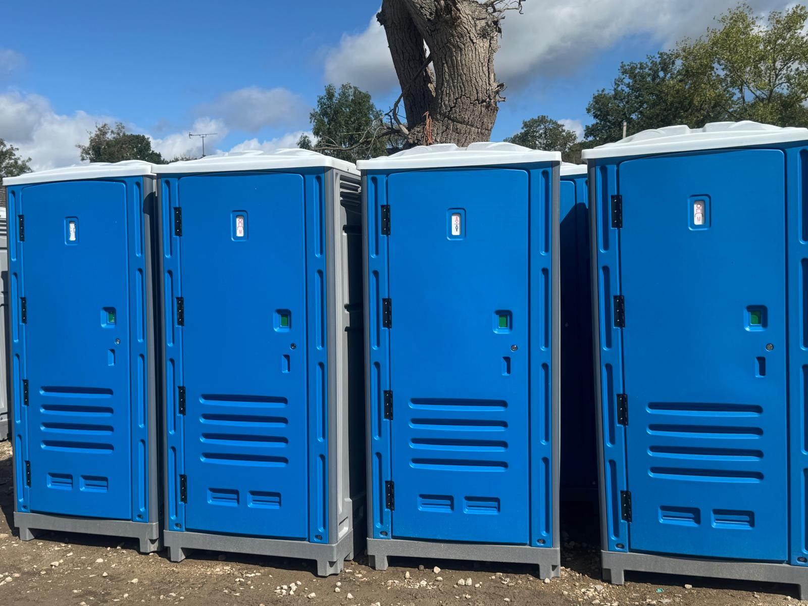 Row of new blue portable toilets